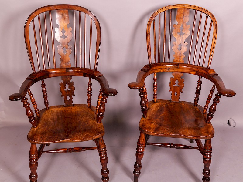 A Near Matching Pair of Yew Wood High Broad Arm Windsor chairs