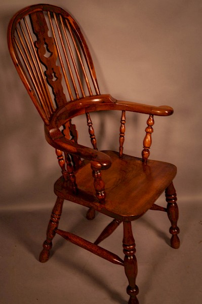 A Yew Wood Broad Arm High Back Windsor Chair