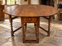 A 17th century gate leg dining table in oak